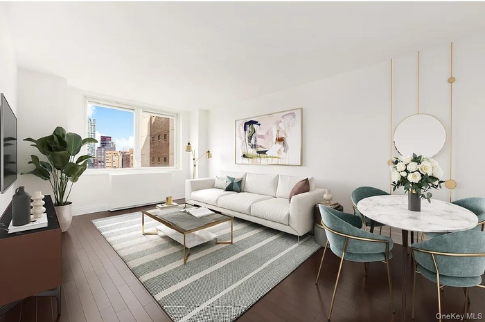 Living room featuring hardwood / wood-style flooring and baseboards