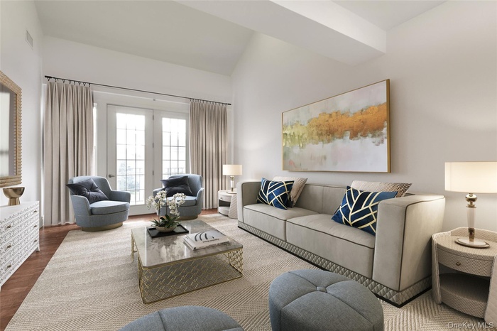 Living room with wood finished floors and lofted ceiling