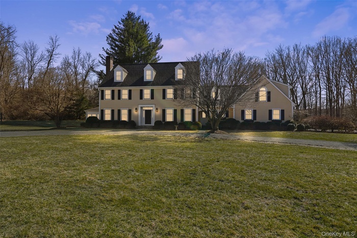 View of front of home with a front yard and a chimney