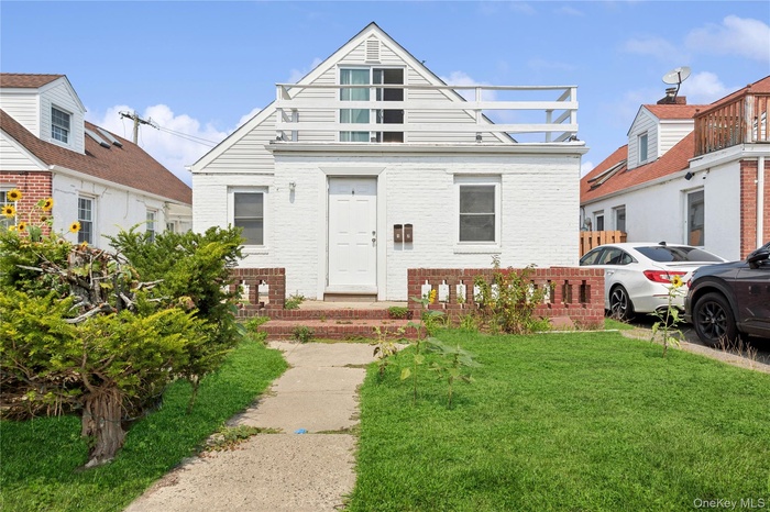 View of front of home featuring a front lawn and brick siding