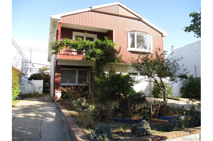 View of front of property with a balcony