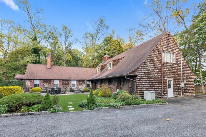 View of front facade featuring a chimney