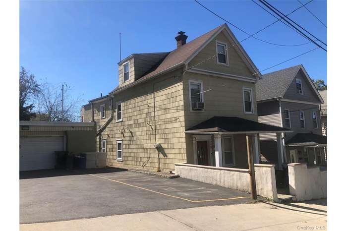 View of home's exterior with a garage and a chimney