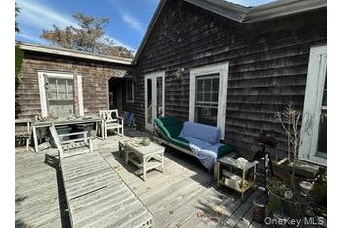 Wooden terrace featuring outdoor lounge area and outdoor dining space