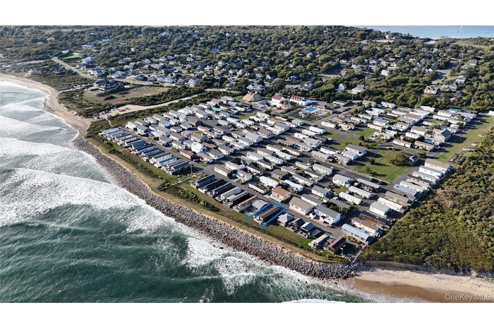 View of property location with expansive beach and nearby suburban area