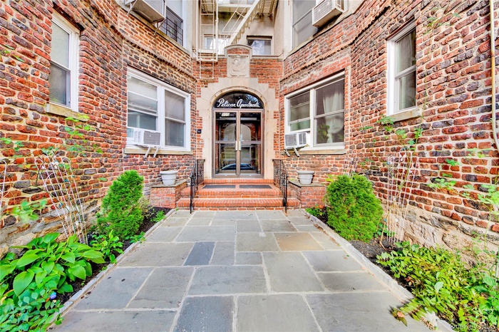 Property entrance with brick siding and french doors