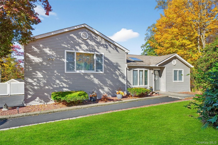 Split level home with a front yard