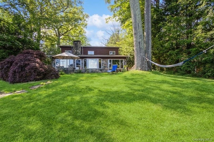 Lake view of property featuring the front lawn facing the lake