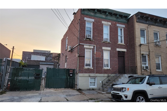 Italianate house with brick siding and a gate
