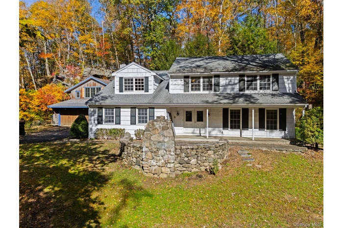 Front of house showing outside fireplace and terrace