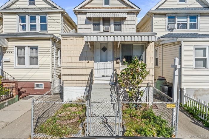 View of front of property featuring a gate and a fenced front yard