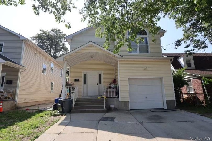 Traditional home with a garage and driveway