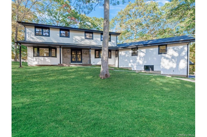 View of front of property with a front yard and a porch
