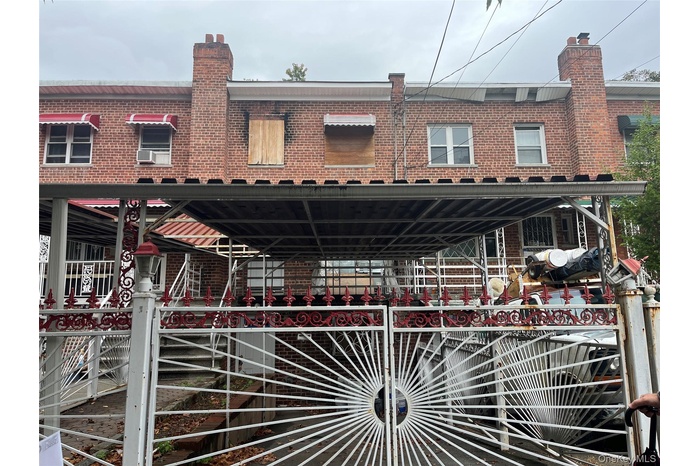 View of front of home with a chimney and brick siding