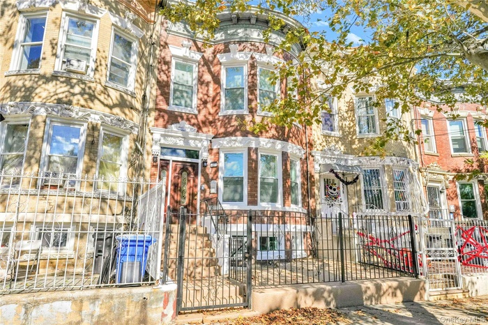 Italianate home featuring a fenced front yard and a gate