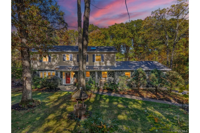 View of front of house featuring a lawn and covered porch