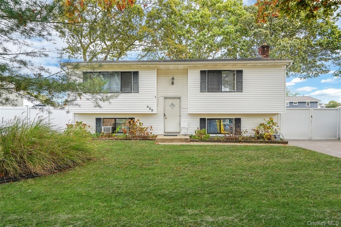 Bi-level home featuring a chimney