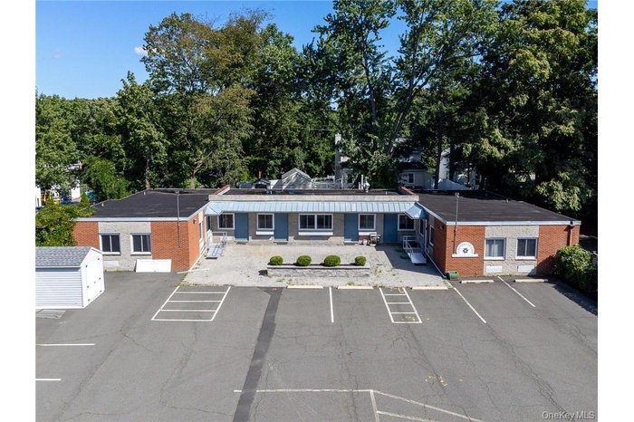 View of property featuring uncovered parking