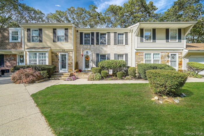 View of front facade featuring stone siding and a front lawn