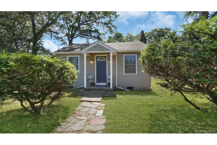Bungalow-style home with a front yard and a chimney