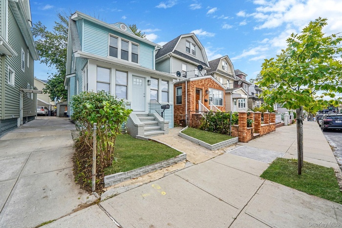 View of front of house with a residential view and a front yard
