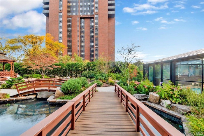 View of property's community with a gazebo, a sunroom, and a swimming pool