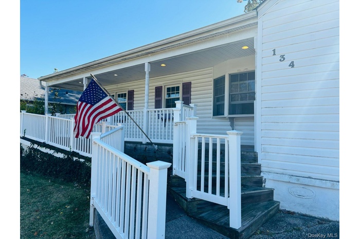 Doorway to property featuring covered porch