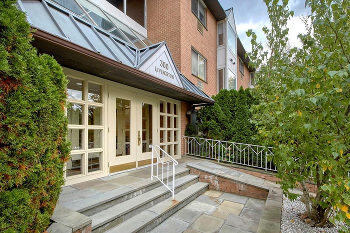 Entrance to property featuring french doors and brick siding