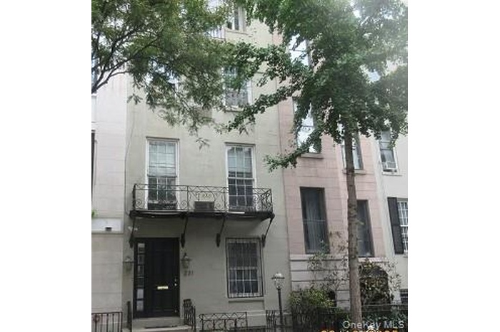 View of front of property featuring a fenced front yard and a balcony