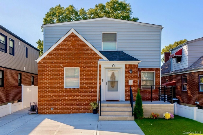 View of front of house with brick siding