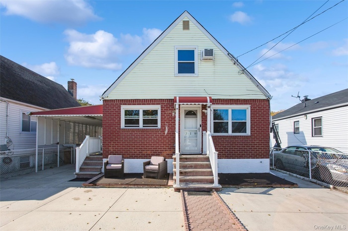 View of front facade featuring brick siding and entry steps