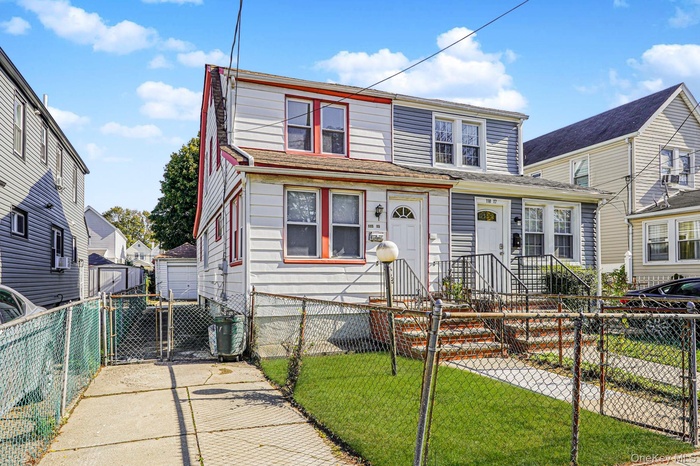 View of front of home with a fenced front yard, a gate, and cooling unit