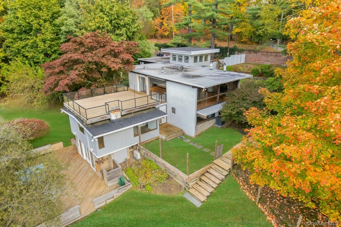 Aerial view of this expansive mid-century modern home set on 1.3 acres offering natural beauty and privacy