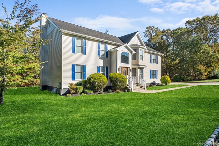 View of front of property with a front lawn and a chimney