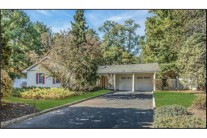 Single story home with asphalt driveway and an attached garage