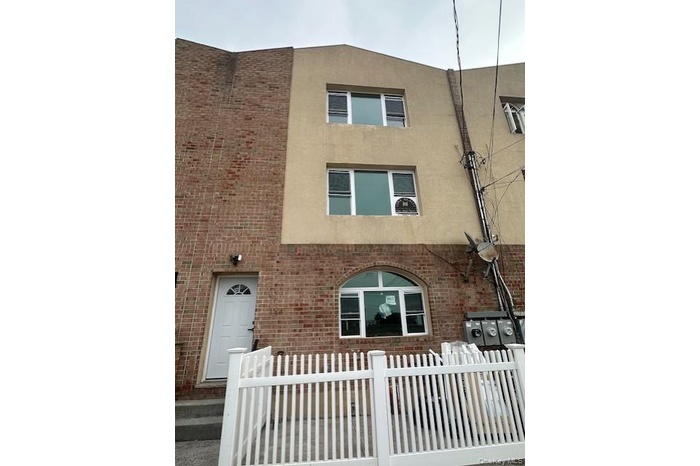 View of property featuring a fenced front yard