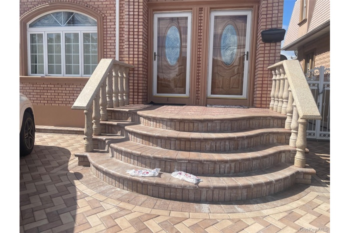Doorway to property featuring brick siding