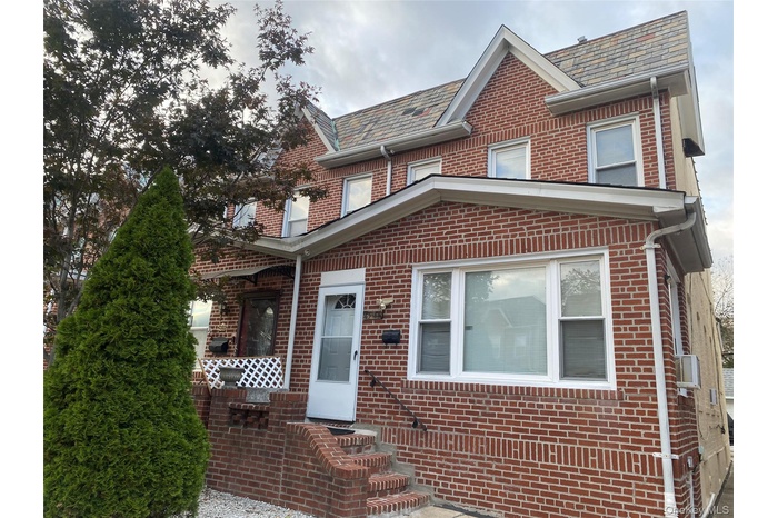 Traditional home with a high end roof and brick siding