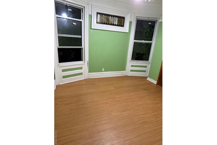 Spare room featuring light wood-type flooring