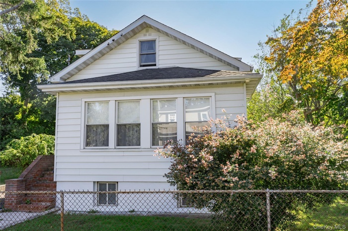 View of property exterior featuring a shingled roof
