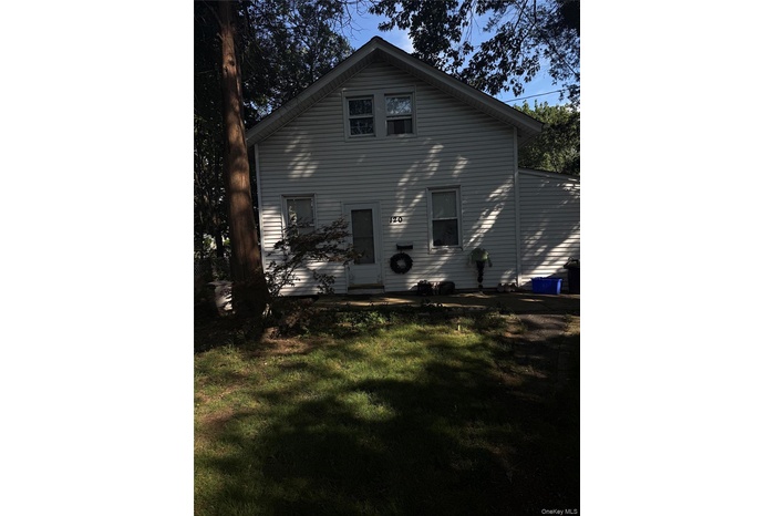 Back of property with a yard