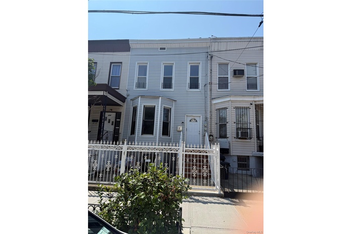View of front of house featuring a fenced front yard and a gate