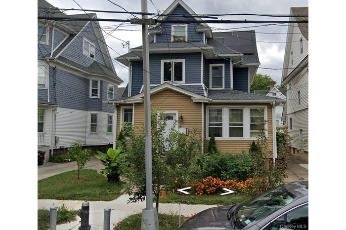 View of front of property featuring a shingled roof