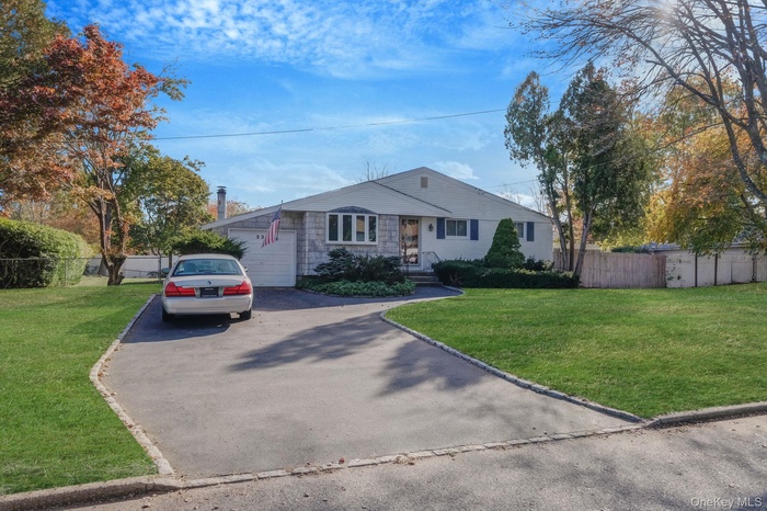 View of front of house with driveway and an attached garage