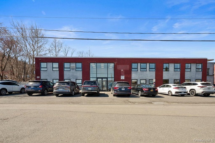 View of commercial location featuring uncovered parking