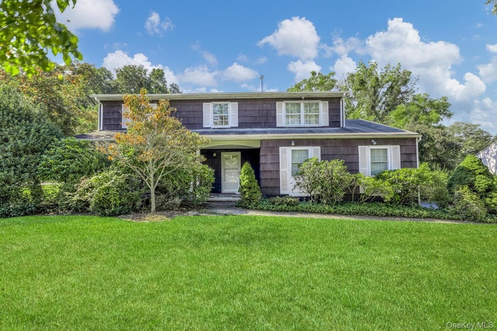 View of front of property with a front lawn