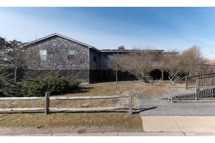 View of front of property with a deck and a chimney