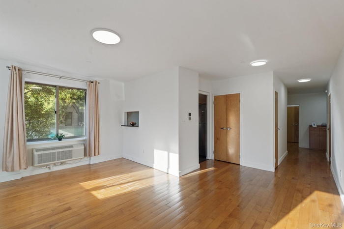 Unfurnished room featuring light wood-style flooring and baseboards