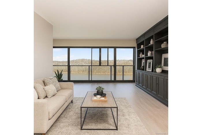 Living area featuring wood finished floors, plenty of natural light, and ornamental molding