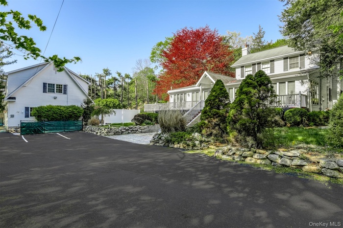 View of patio / terrace featuring fence, covered porch, and stairway